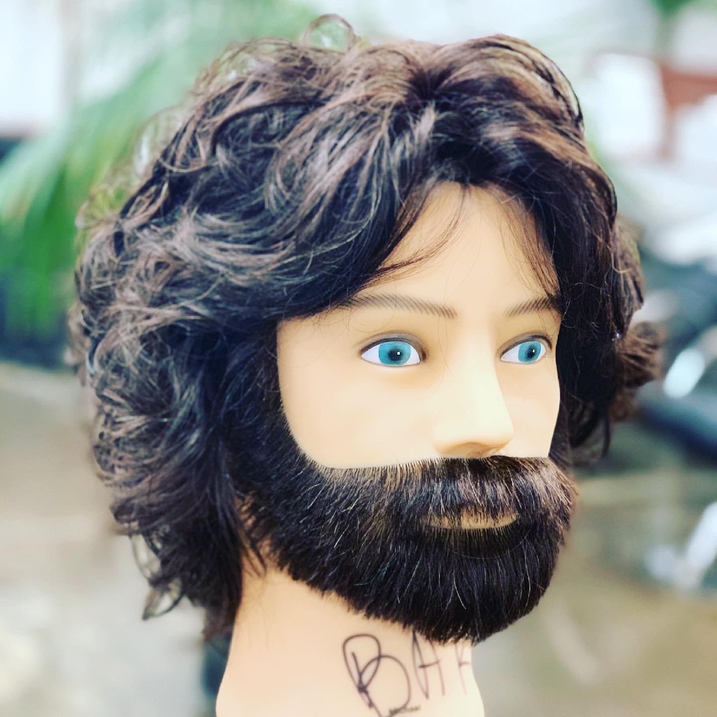 A practice head styled with a full beard and long layered hair